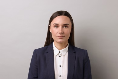 Photo of Portrait of businesswoman on light grey background