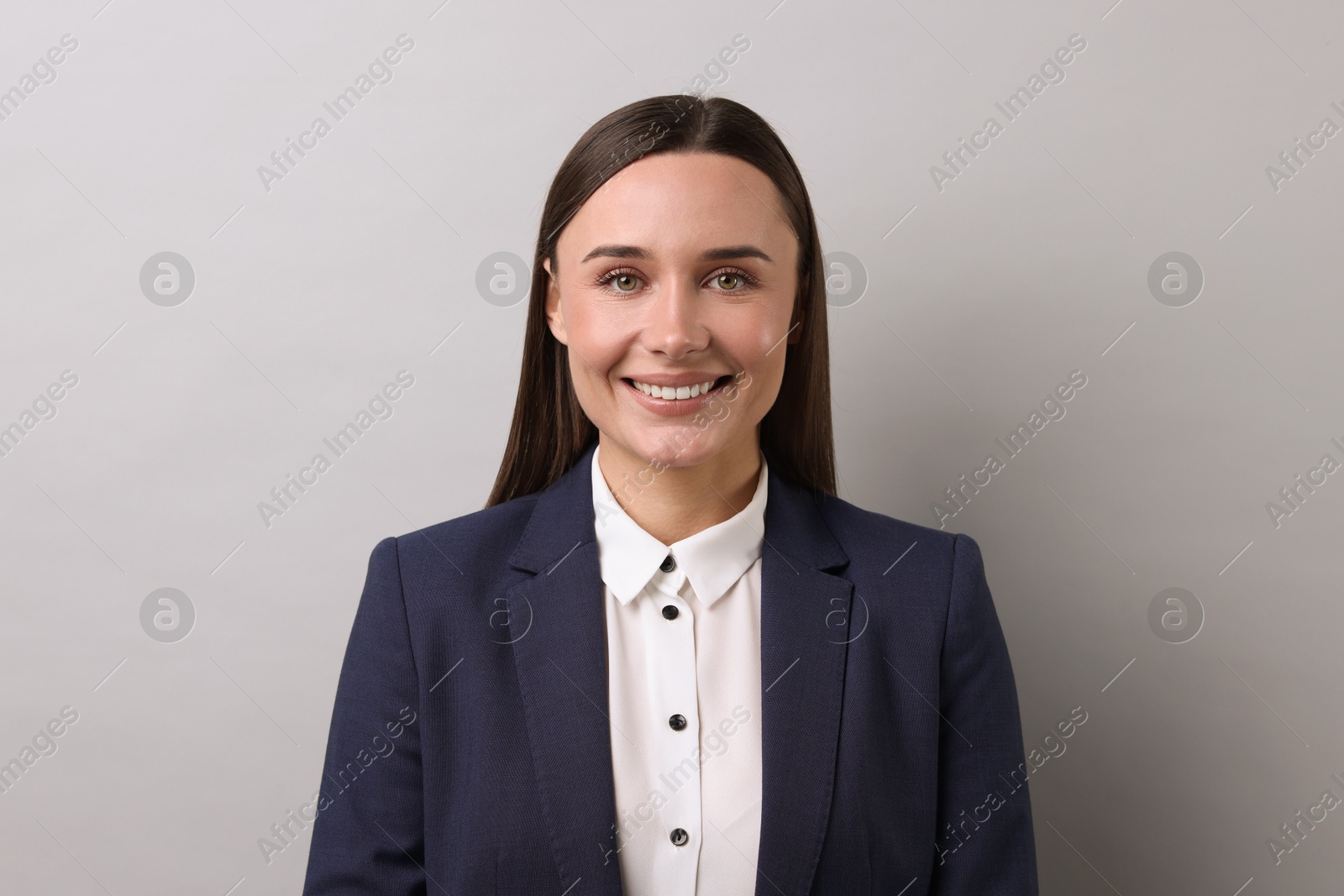 Photo of Portrait of businesswoman on light grey background