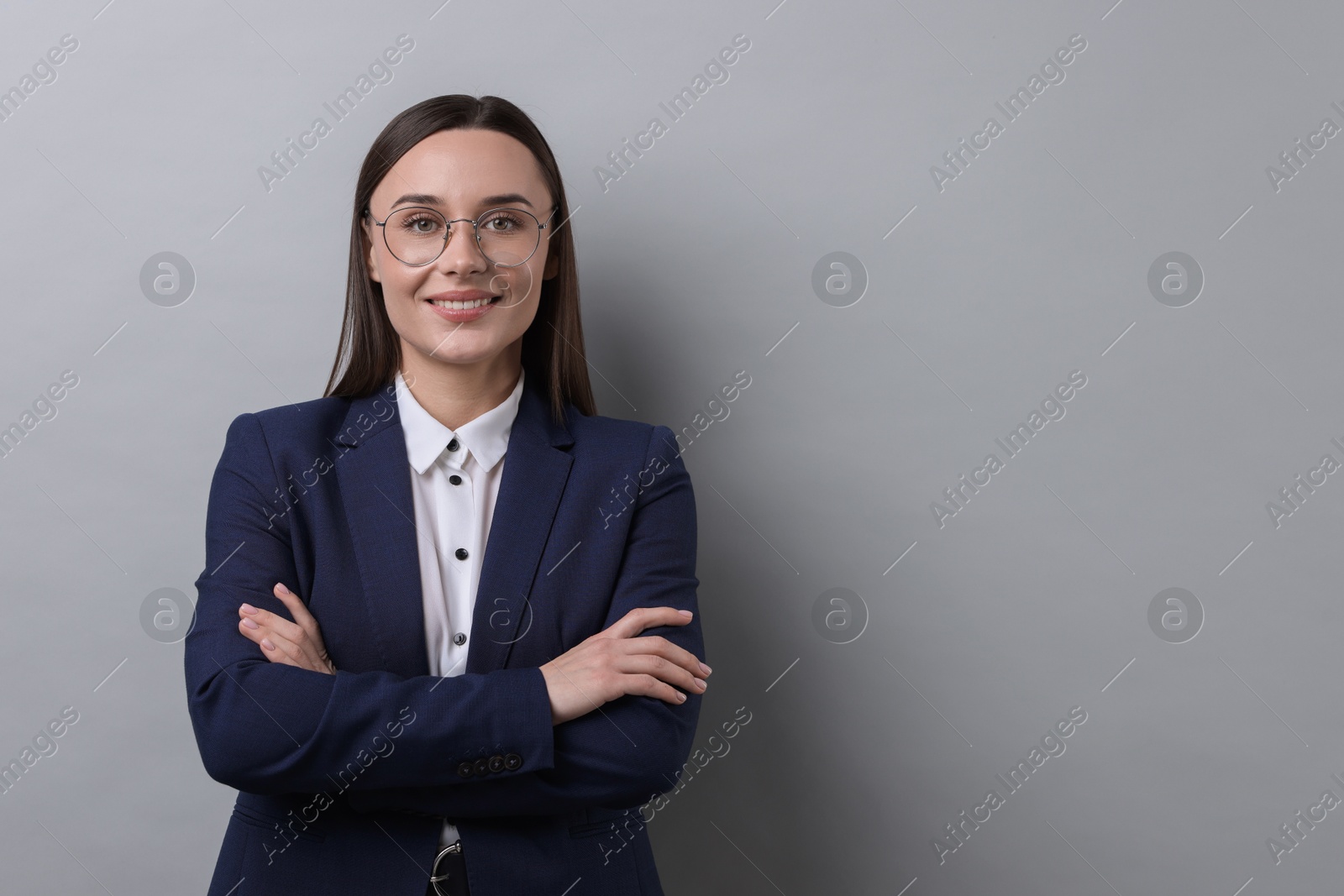 Photo of Portrait of businesswoman in glasses on light grey background, space for text