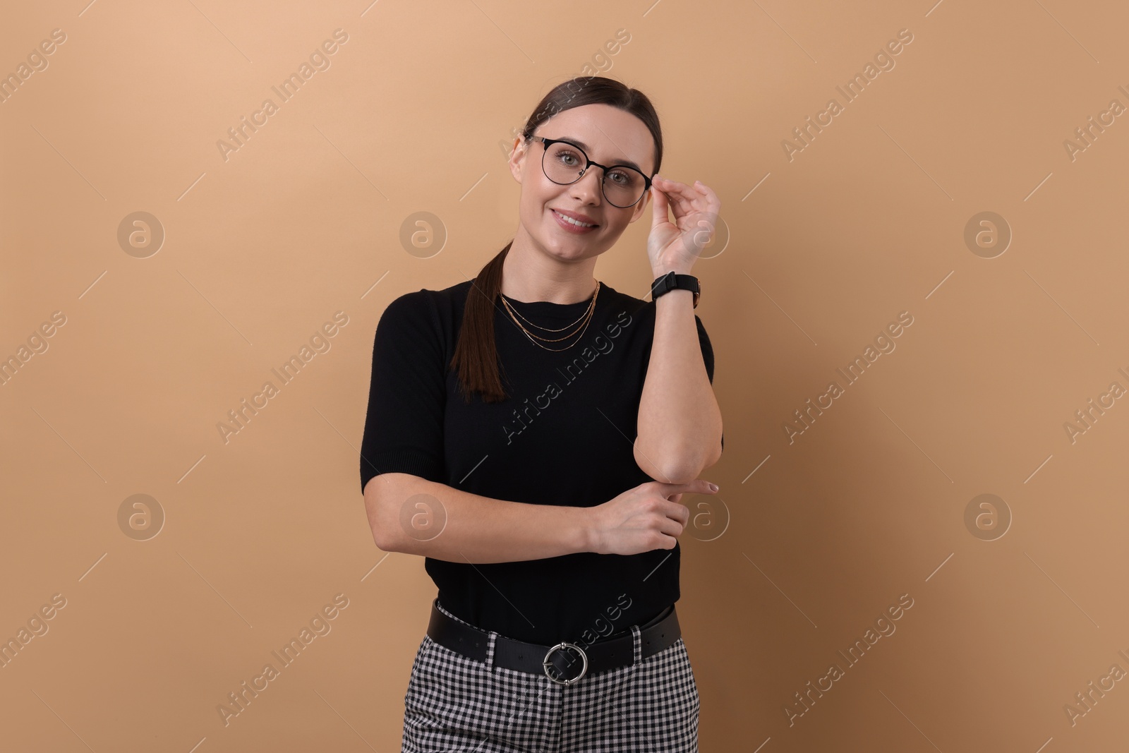 Photo of Portrait of businesswoman in glasses on beige background