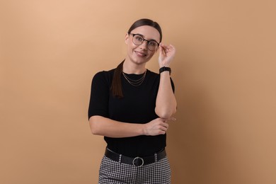 Photo of Portrait of businesswoman in glasses on beige background