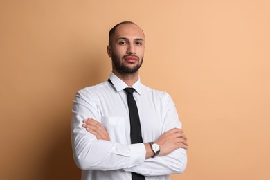 Portrait of businessman with necktie on beige background