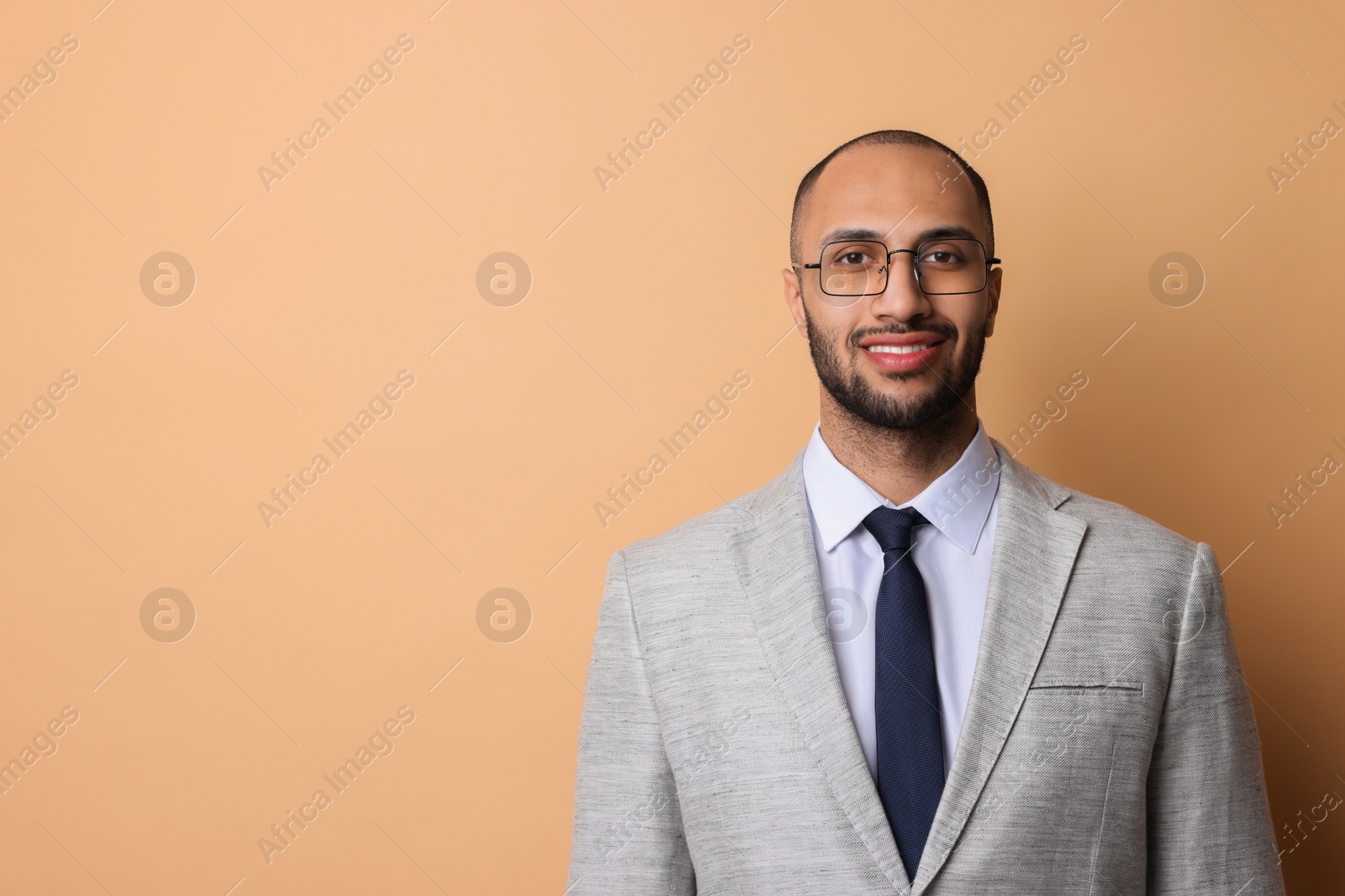 Photo of Portrait of businessman in glasses on beige background, space for text