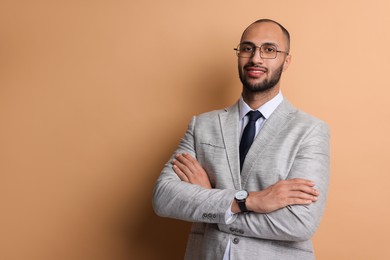 Photo of Portrait of businessman in glasses on beige background, space for text