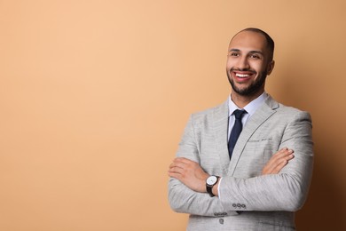 Portrait of businessman on beige background, space for text