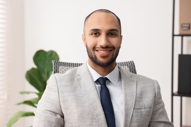 Photo of Portrait of happy businessman in jacket indoors