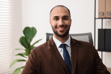 Photo of Portrait of happy businessman in jacket indoors