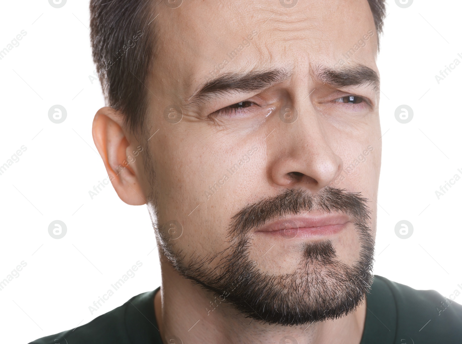 Photo of Sad man crying on white background, closeup