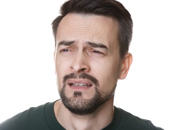 Photo of Portrait of sad man crying on white background