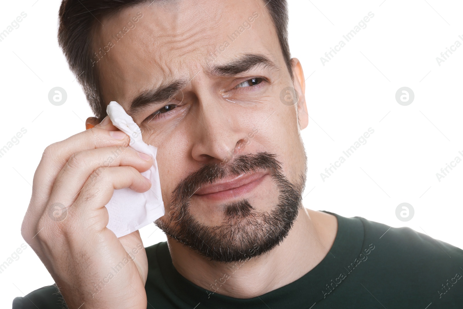 Photo of Sad man with paper tissue crying on white background