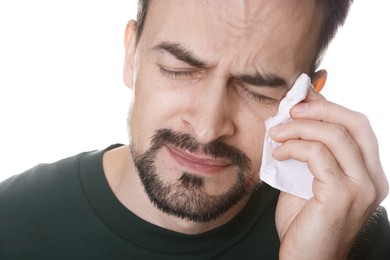 Sad man with paper tissue crying on white background