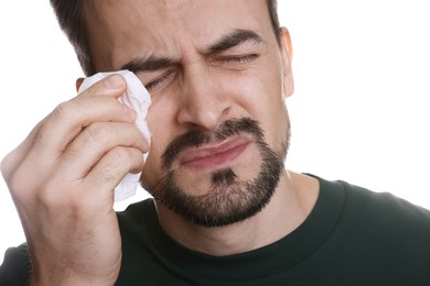 Photo of Sad man with paper tissue crying on white background