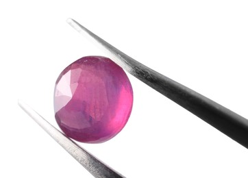 Photo of Tweezers with shiny pink gemstone isolated on white