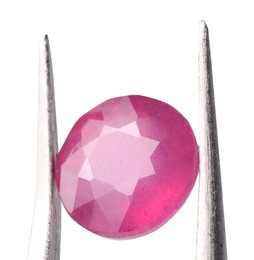 Photo of Tweezers with shiny pink gemstone isolated on white