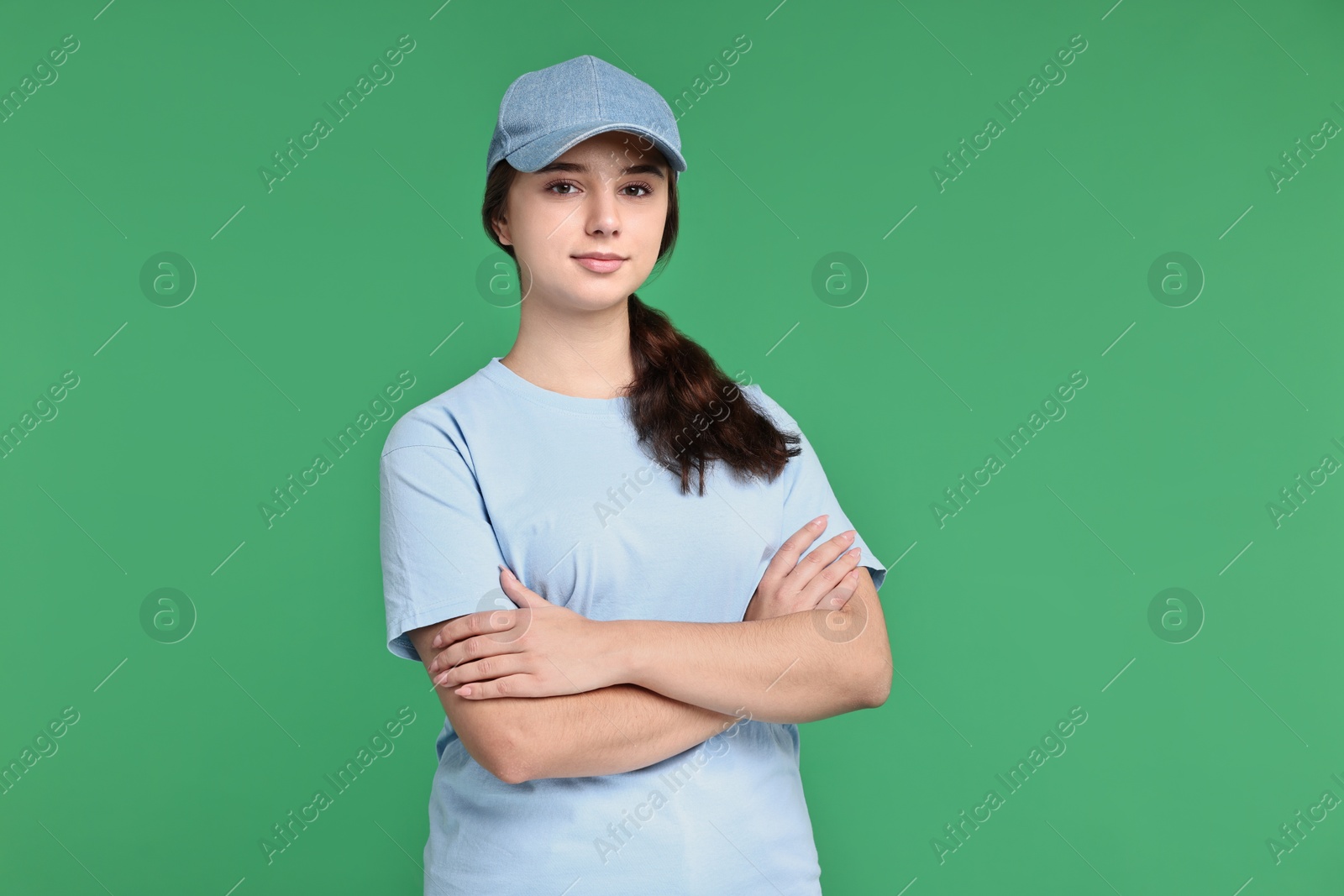 Photo of Girl in uniform on green background. Work for teenagers