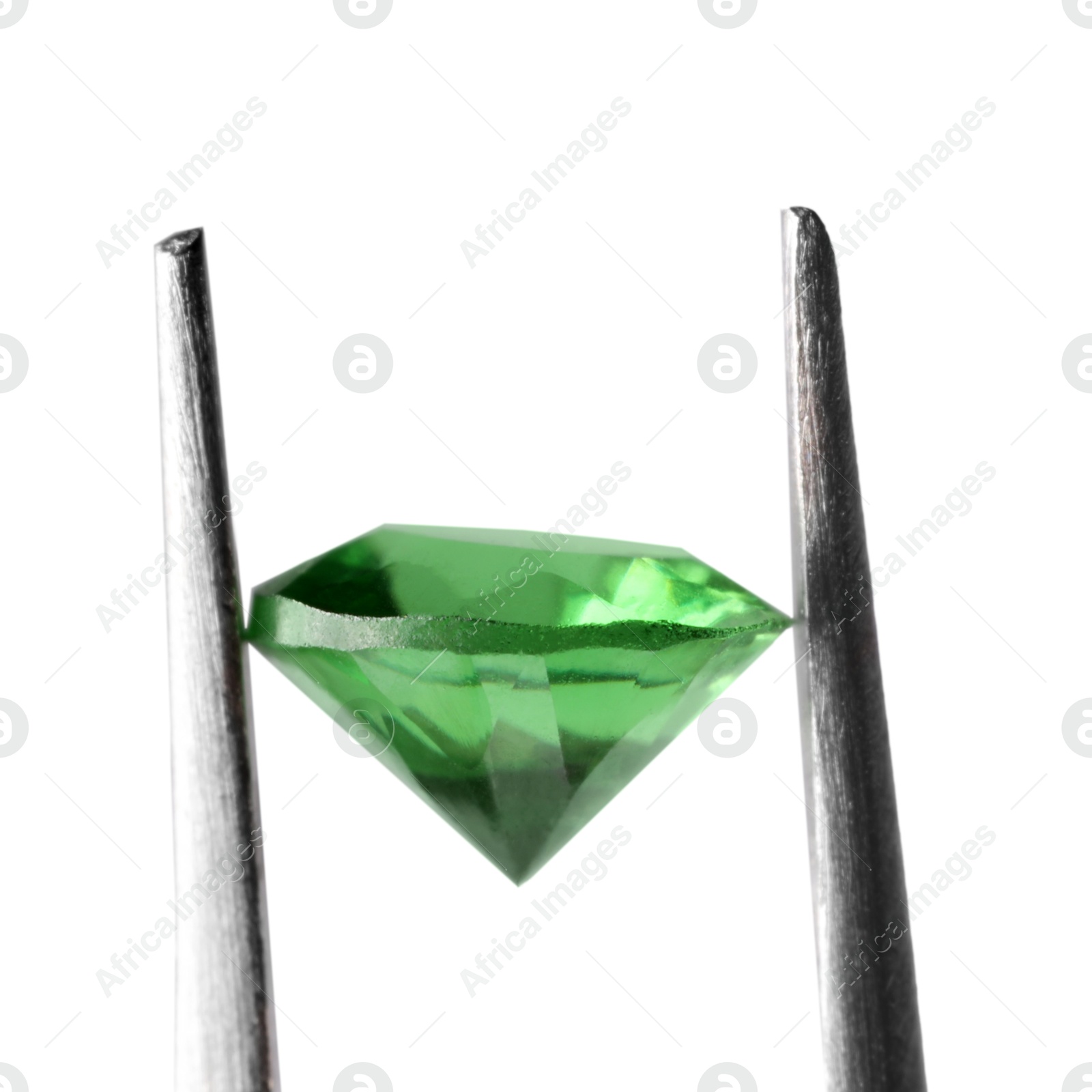 Photo of Tweezers with shiny green gemstone isolated on white