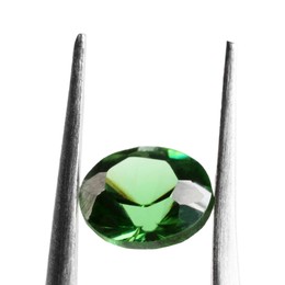 Photo of Tweezers with shiny green gemstone isolated on white