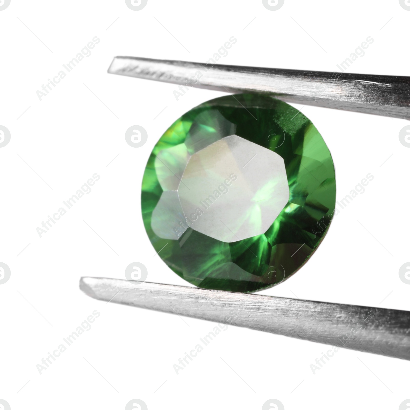 Photo of Tweezers with shiny green gemstone isolated on white