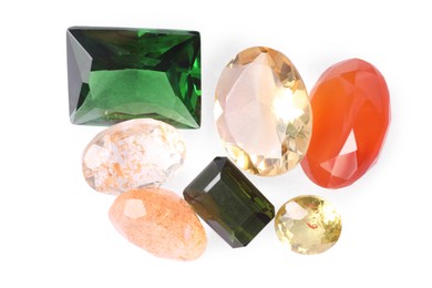 Photo of Different colorful shiny gemstones isolated on white