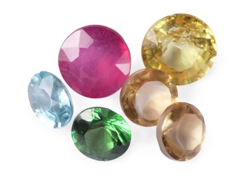 Photo of Different colorful shiny gemstones isolated on white