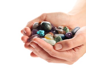 Woman holding different natural mineral stones on white background, closeup