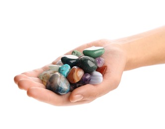 Photo of Woman holding different natural mineral stones on white background, closeup