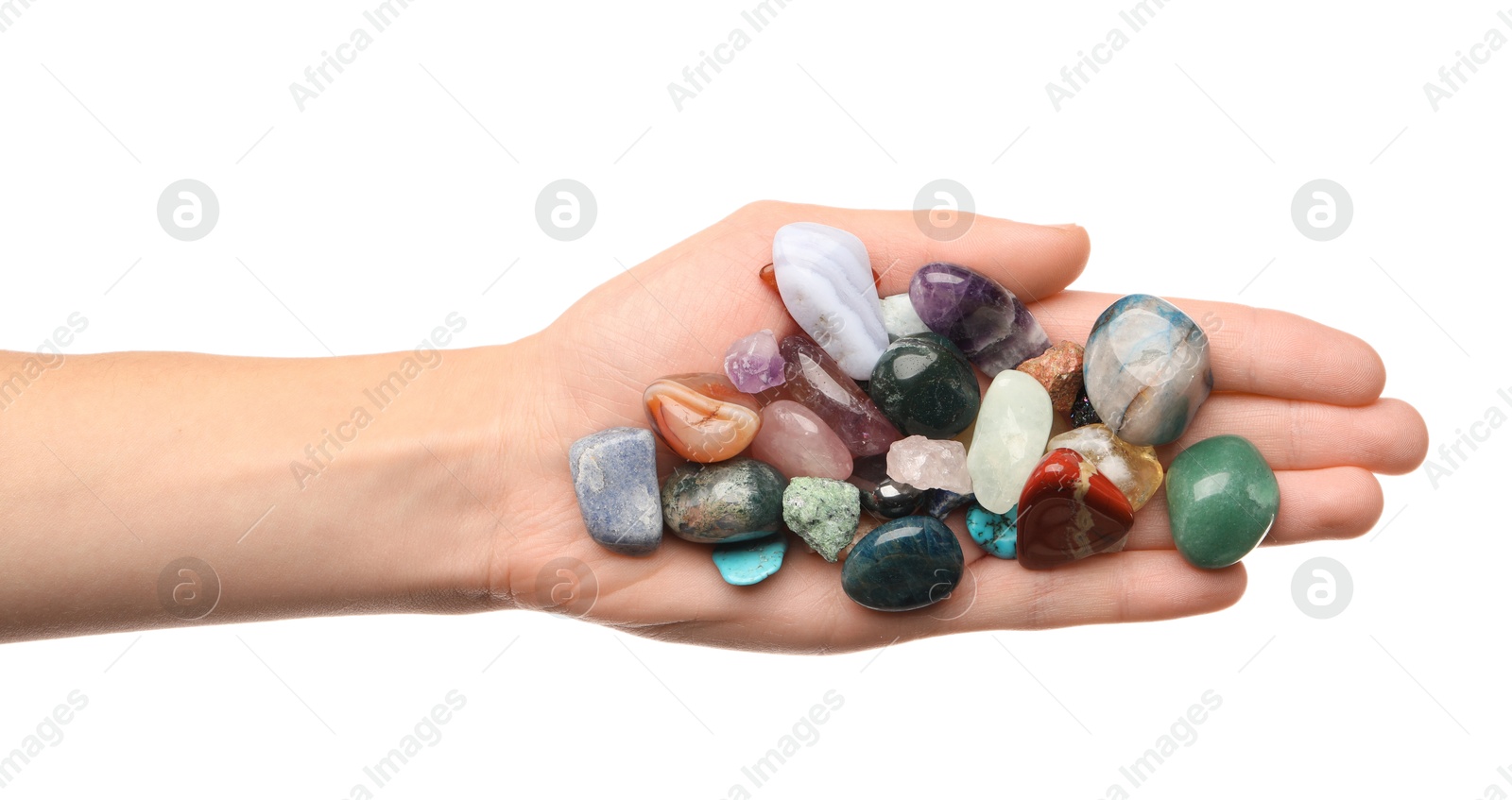 Photo of Woman holding different natural mineral stones on white background, top view