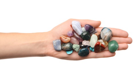 Photo of Woman holding different natural mineral stones on white background, top view