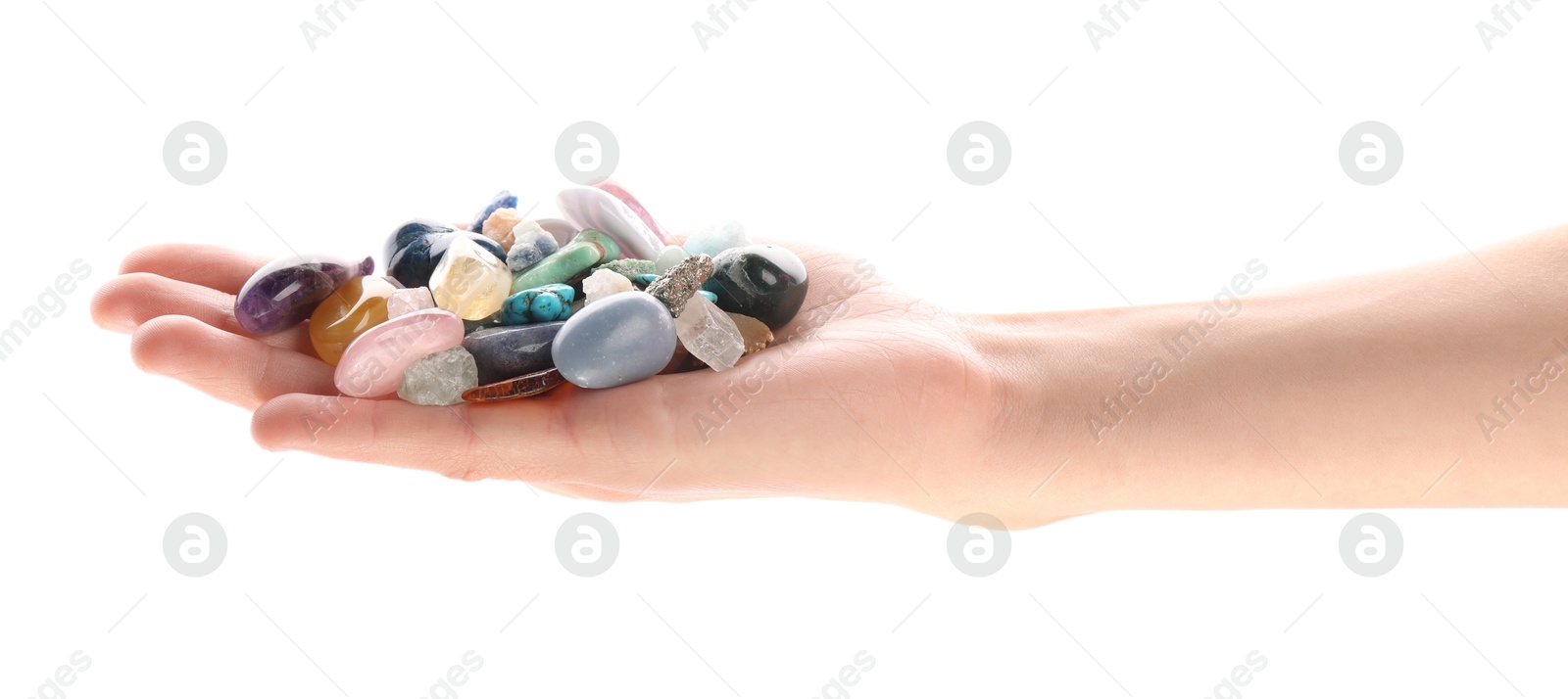 Photo of Woman holding different natural mineral stones on white background, closeup