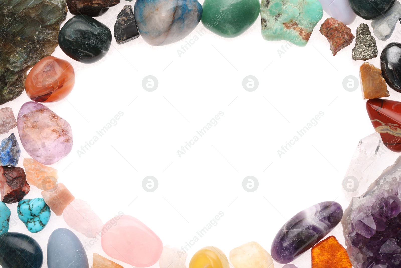 Photo of Frame of different natural mineral stones isolated on white, top view