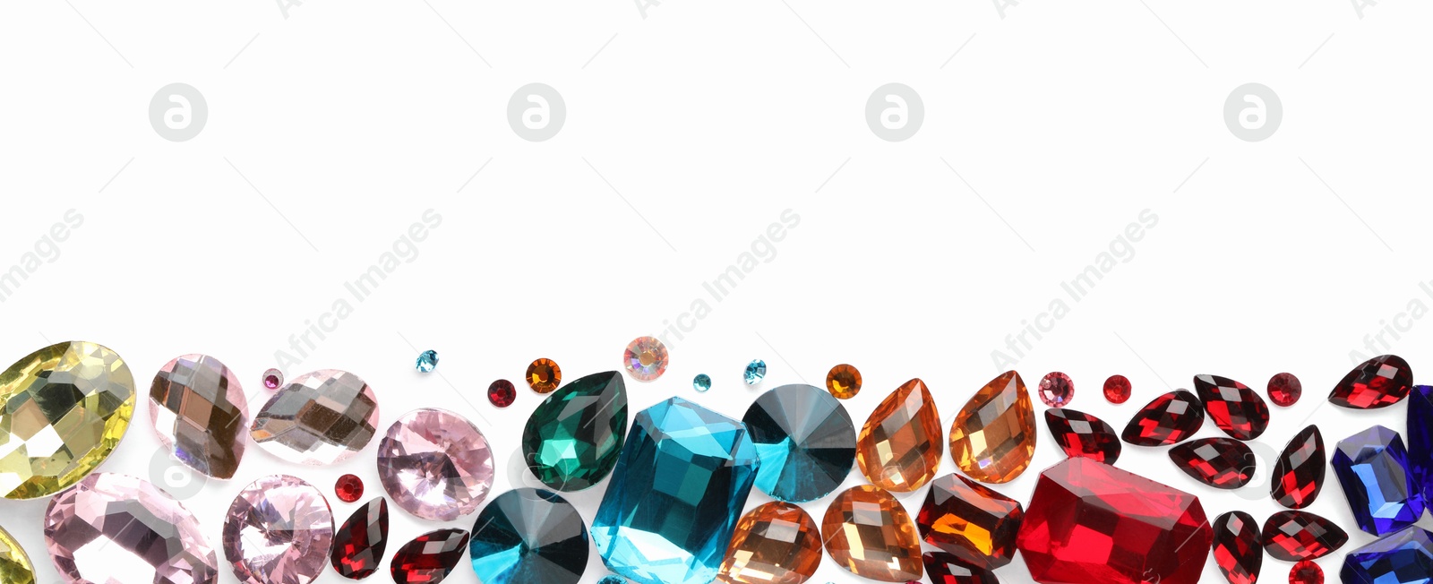 Photo of Different shiny gemstones on white background, flat lay. Space for text