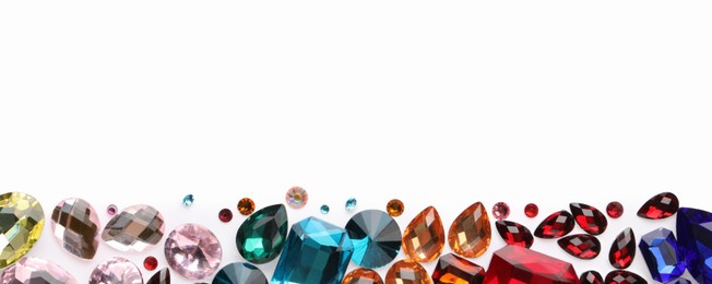 Photo of Different shiny gemstones on white background, flat lay. Space for text