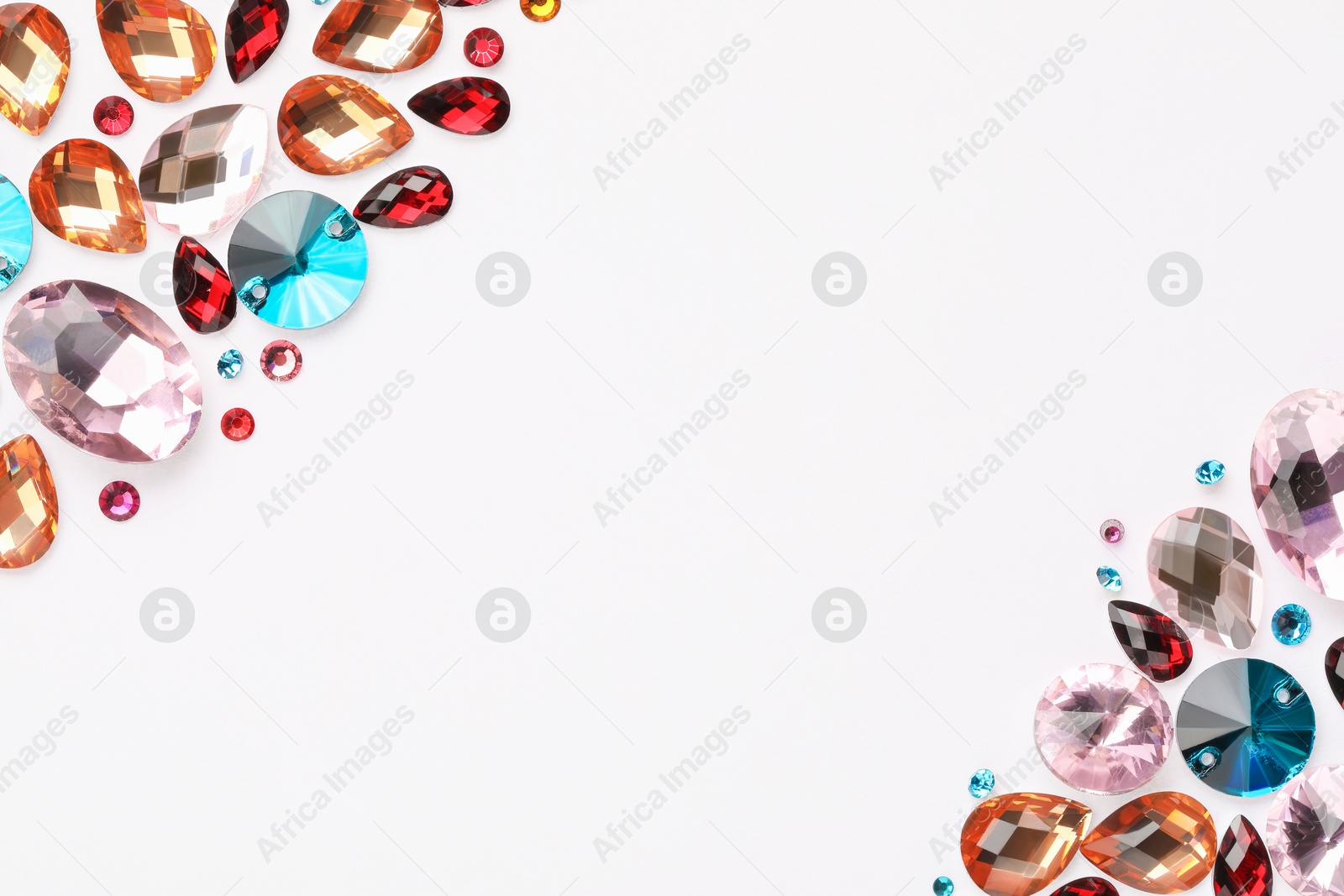 Photo of Different shiny gemstones on white background, flat lay. Space for text