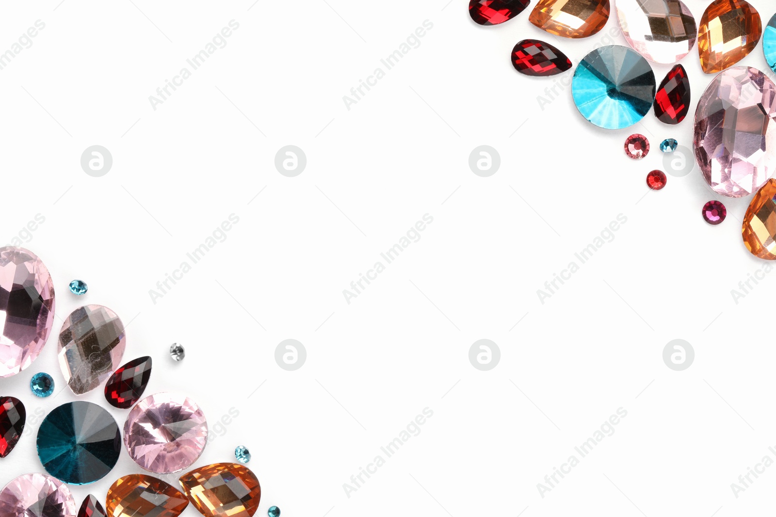 Photo of Different shiny gemstones on white background, flat lay. Space for text