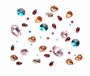 Photo of Different shiny gemstones on white background, flat lay