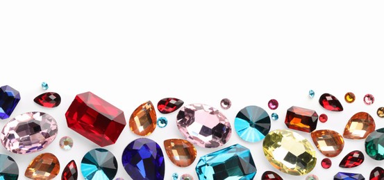 Photo of Different shiny gemstones on white background, flat lay. Space for text