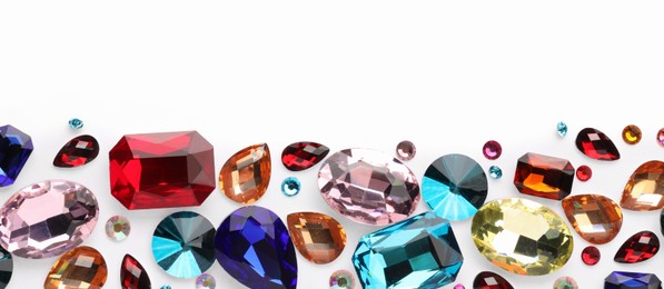 Photo of Different shiny gemstones on white background, flat lay. Space for text