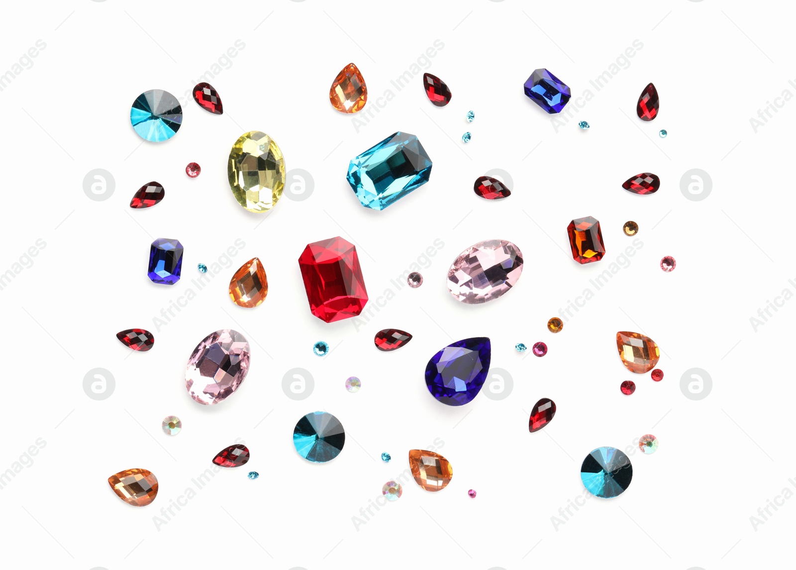 Photo of Different shiny gemstones on white background, flat lay