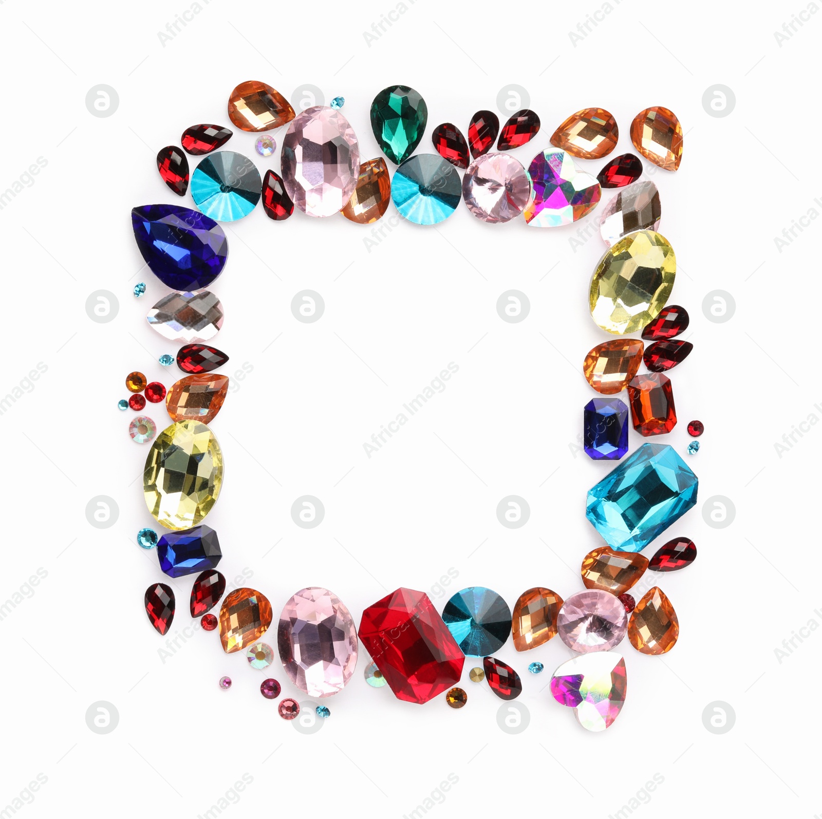 Photo of Frame of different shiny gemstones on white background, flat lay. Space for text