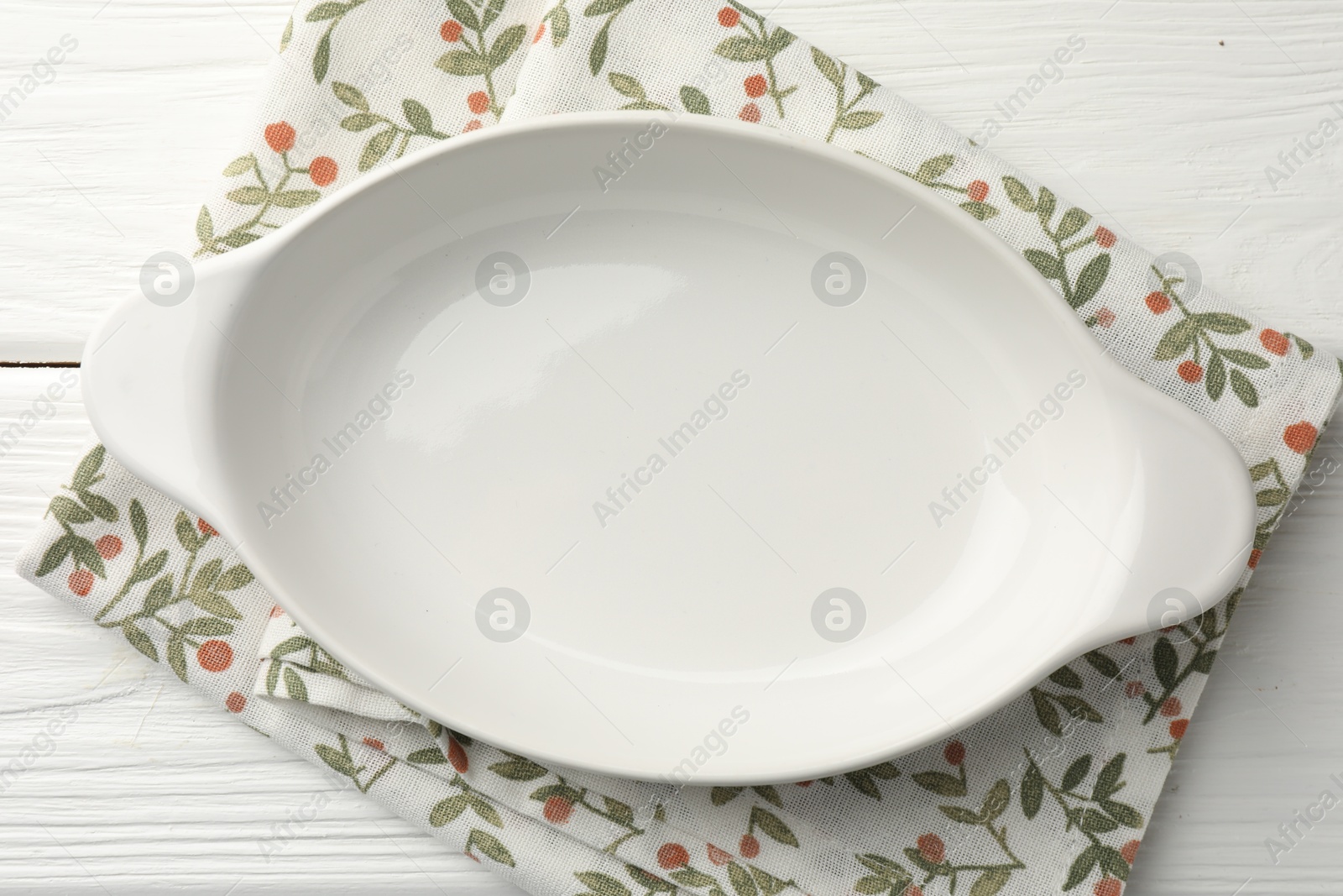 Photo of One ceramic casserole on white wooden table, top view