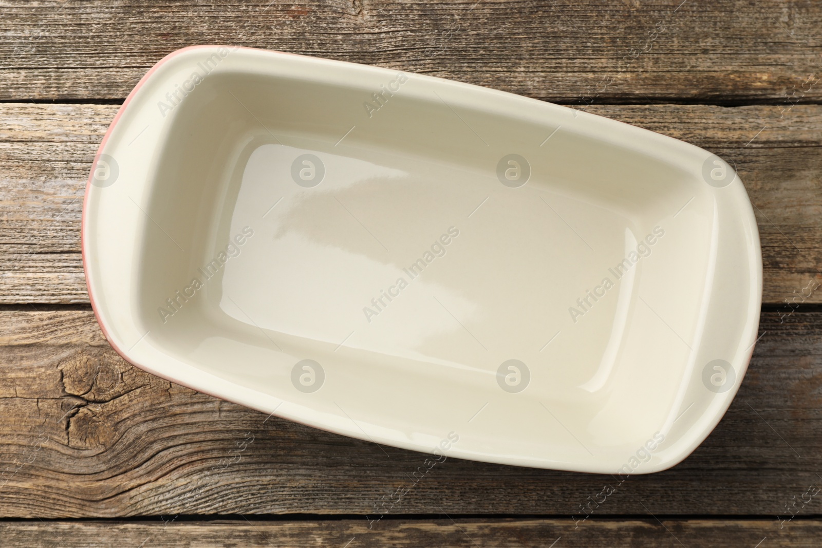 Photo of One ceramic casserole on wooden table, top view