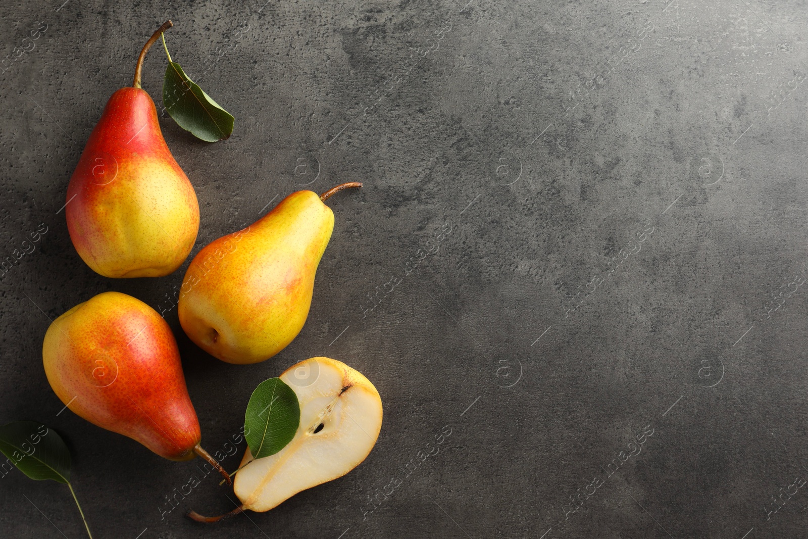 Photo of Ripe juicy pears on grey table, flat lay. Space for text