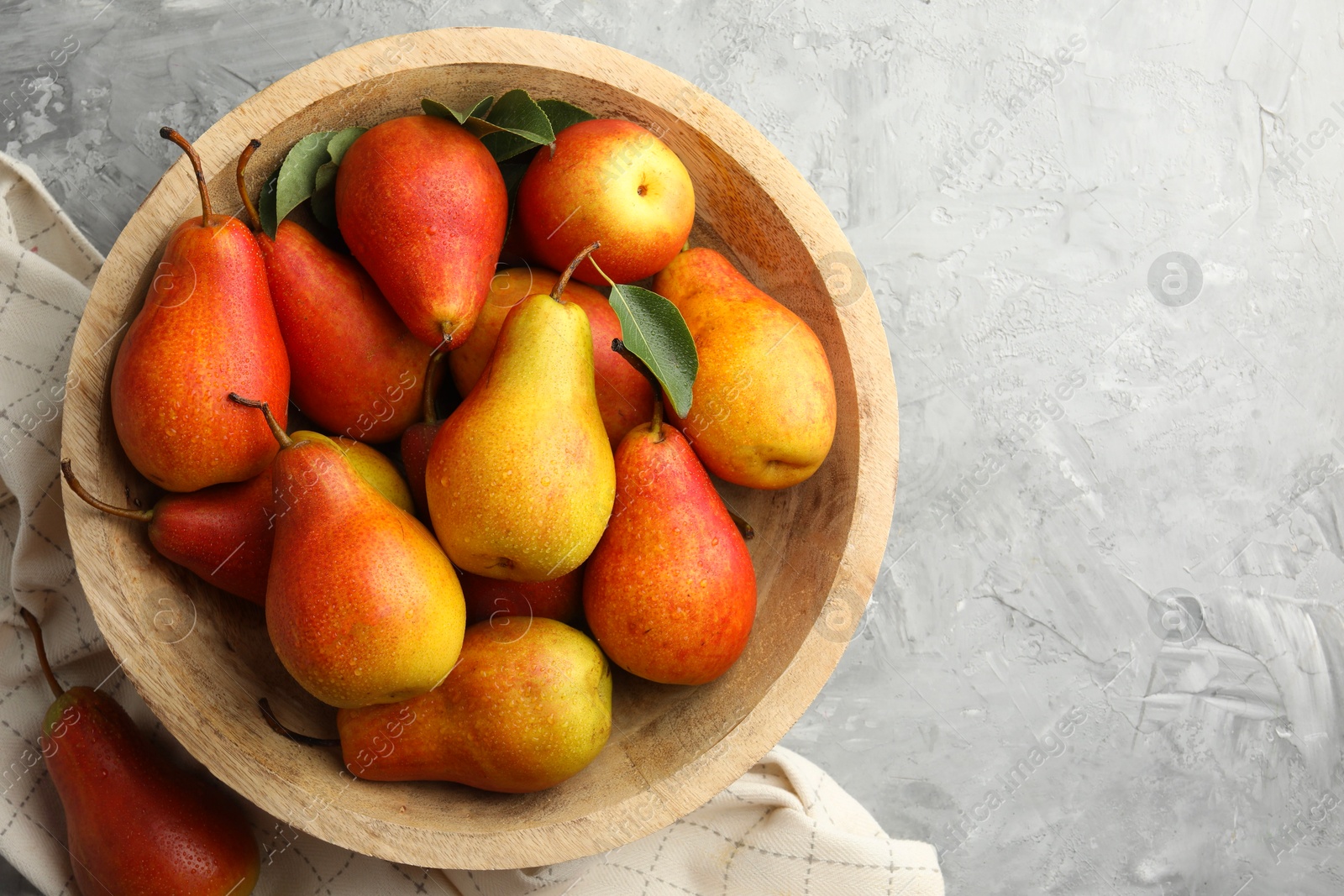 Photo of Ripe juicy pears on grey table, top view