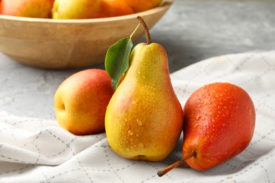 Photo of Ripe juicy pears on grey table, closeup