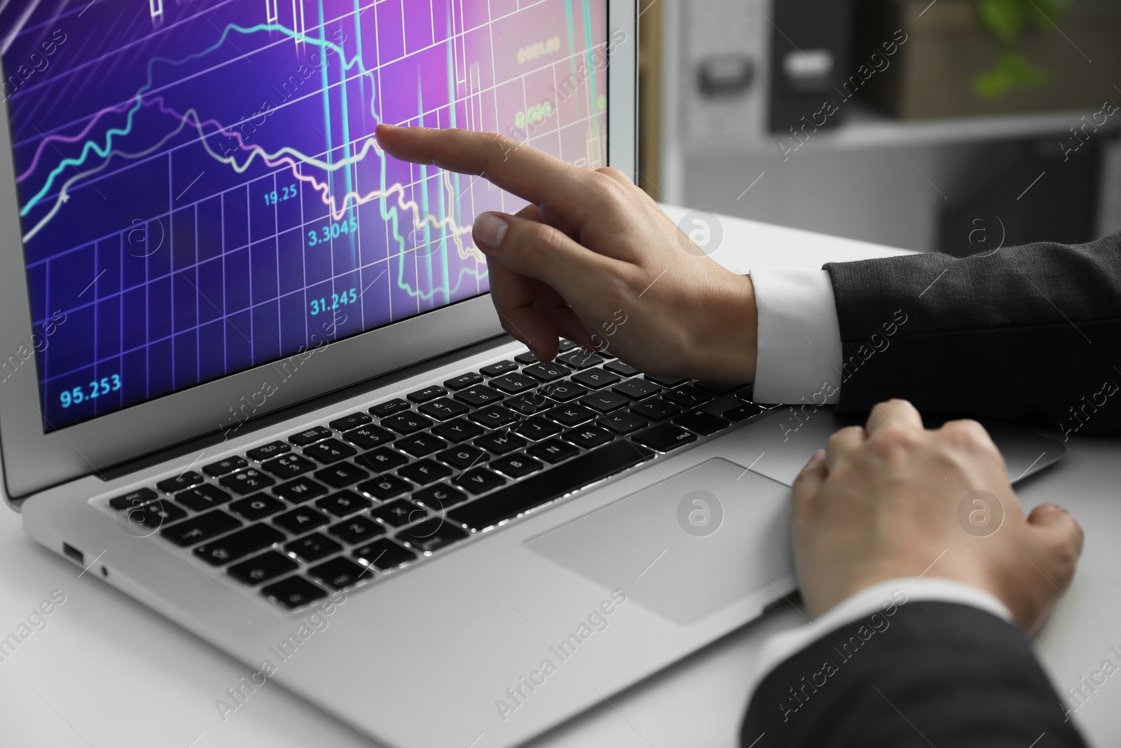 Photo of Businesswoman using laptop at white table indoors, closeup. Modern technology