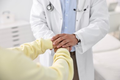 Photo of Healthcare worker supporting patient in hospital, closeup