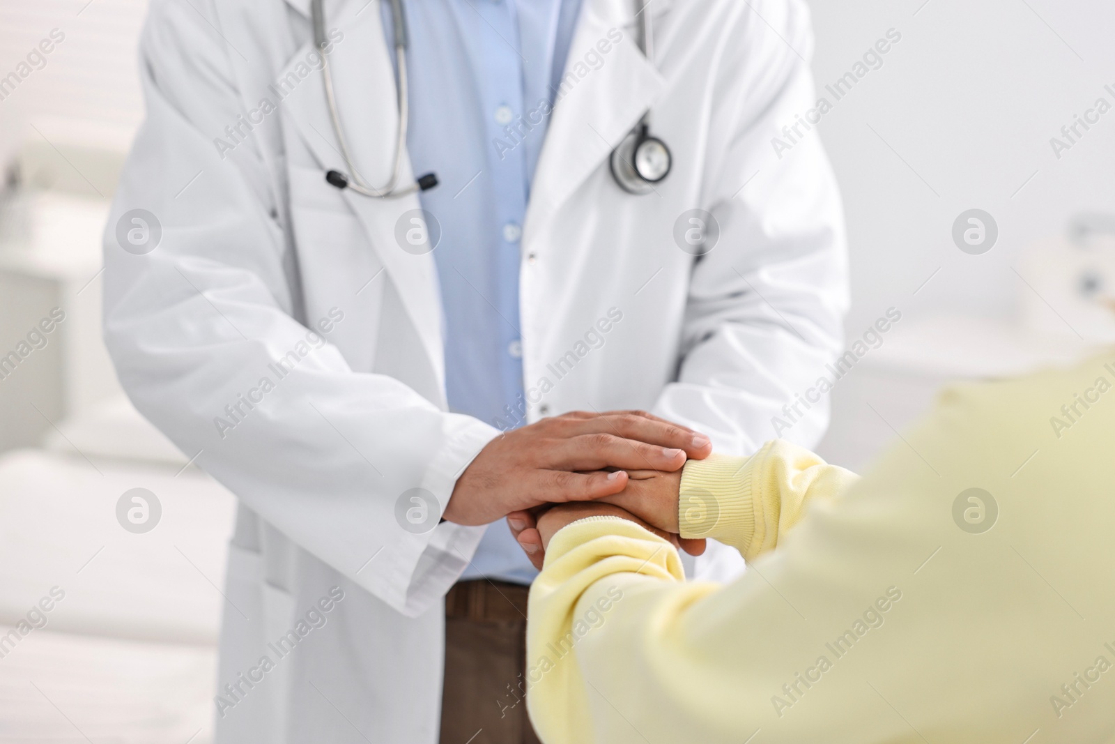 Photo of Healthcare worker supporting patient in hospital, closeup