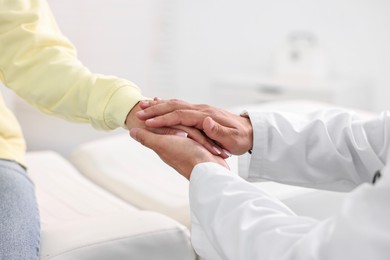 Photo of Healthcare worker supporting patient in hospital, closeup