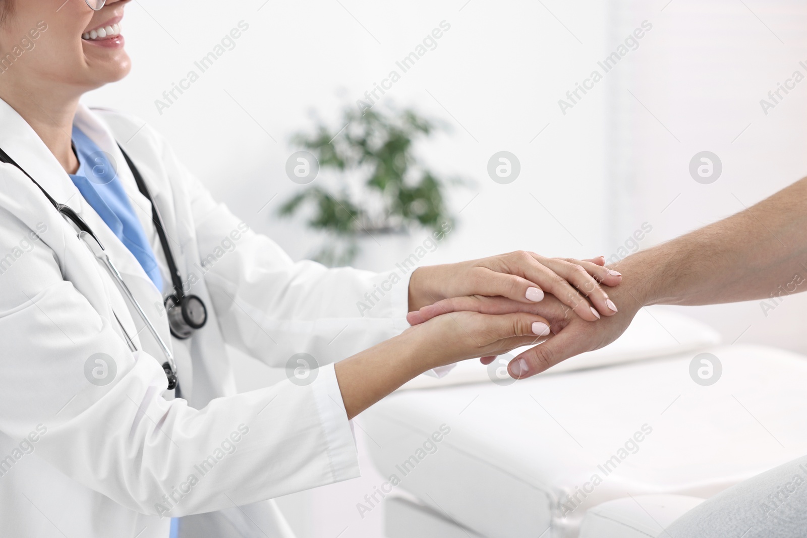 Photo of Healthcare worker supporting patient in hospital, closeup