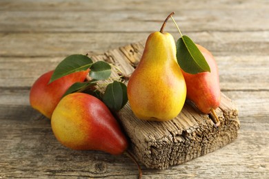 Photo of Many ripe juicy pears on wooden table